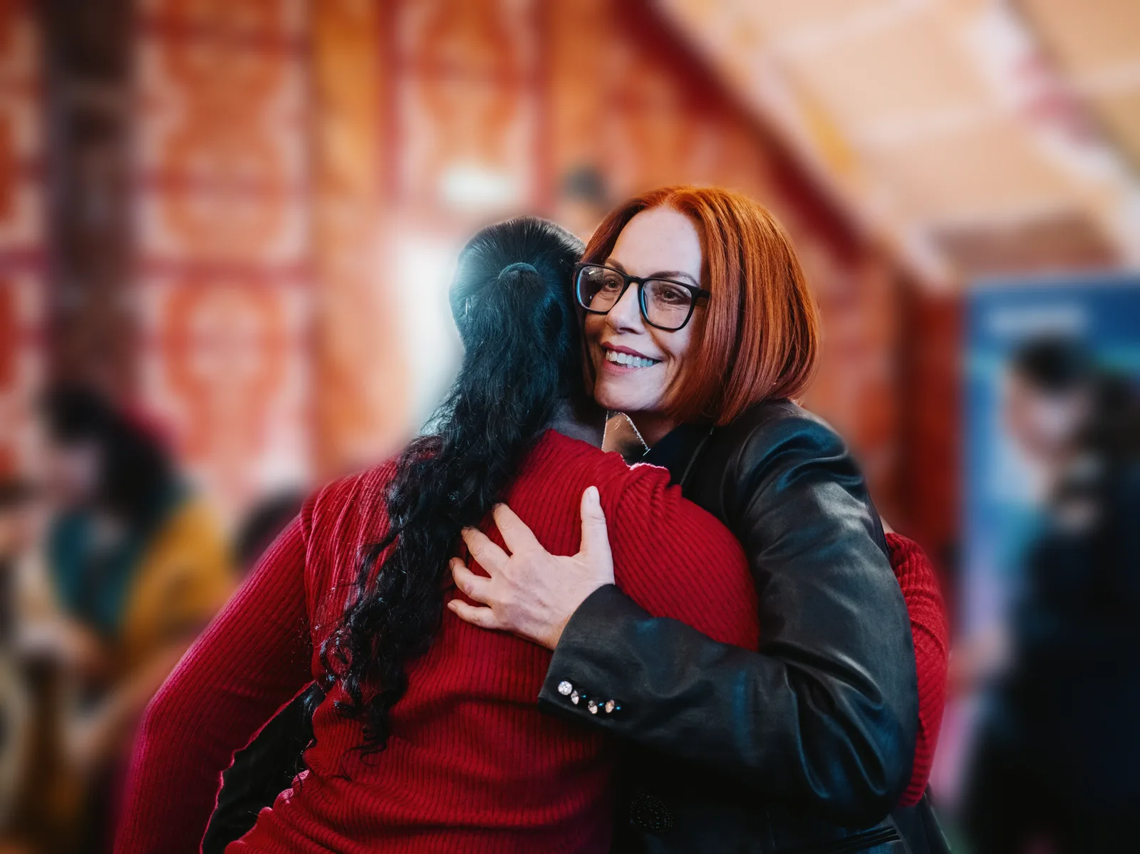 Simone embracing someone at a Race Unity Hui event